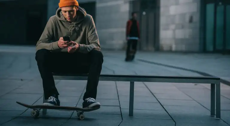 A skateboarder sitting on a bench